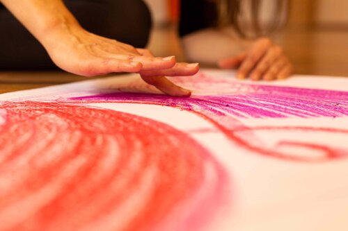 Finger malen auf Papier - rote und rosa Spuren